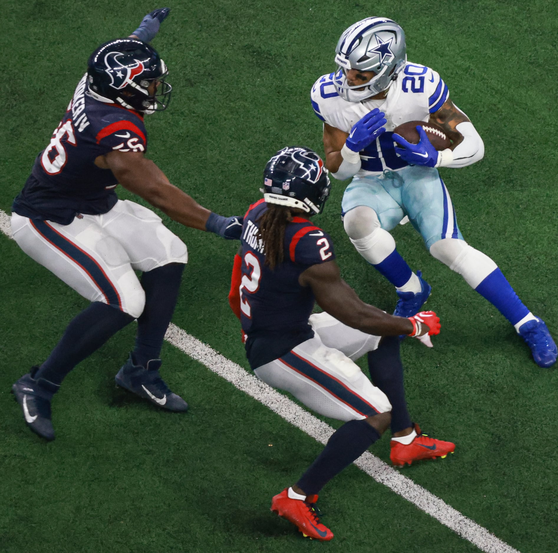 Houston Texans defensive tackle Thomas Booker IV (56) in between