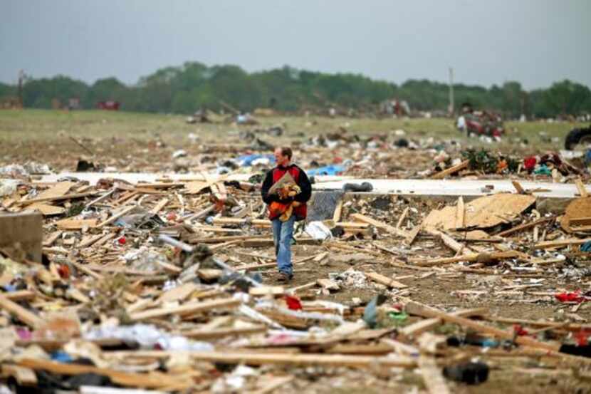 
Mark Wade of Vilonia, Ark., looked through debris Tuesday after deadly tornadoes ripped...
