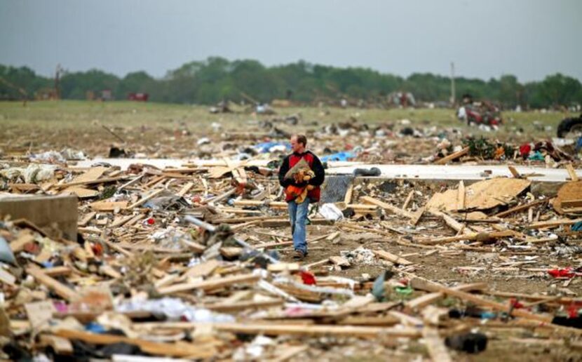 
Mark Wade of Vilonia, Ark., looked through debris Tuesday after deadly tornadoes ripped...