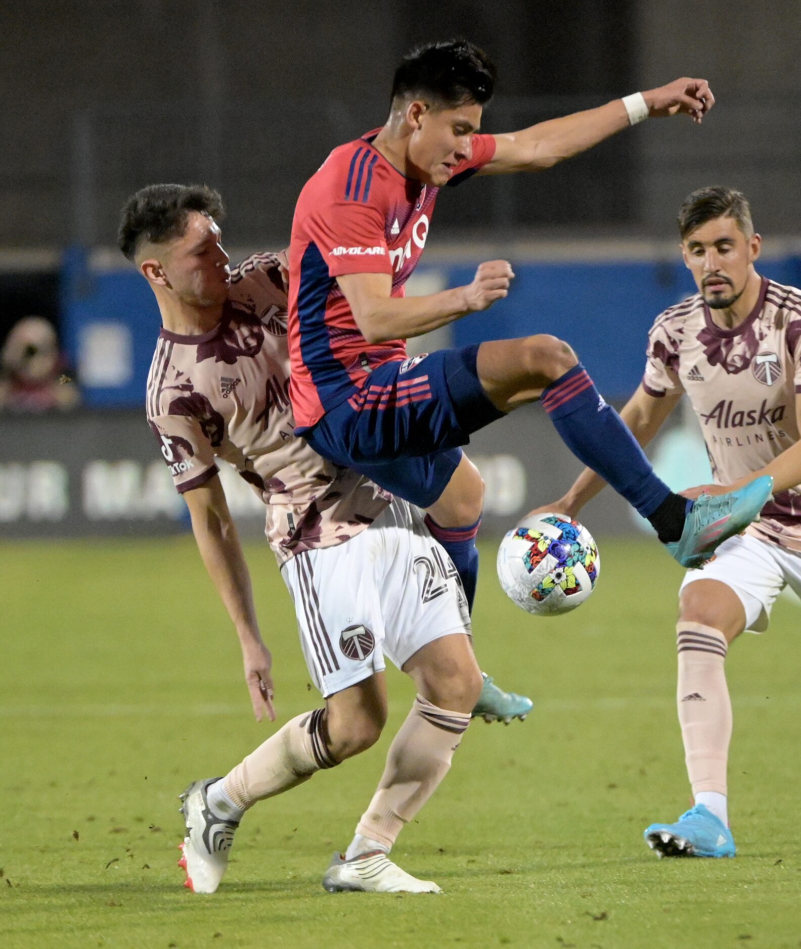 FC Dallas defender Marco Farfan (4) goes after a ball with Portland Timbers midfielder David...