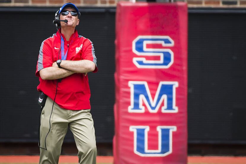 SMU head coach Chad Morris watches his players scrimmage during the team's spring football...