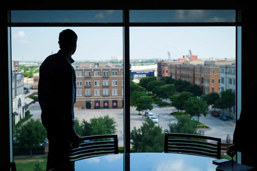 Frisco City Manager George Purefoy looks out the windows of his office in the municipal...