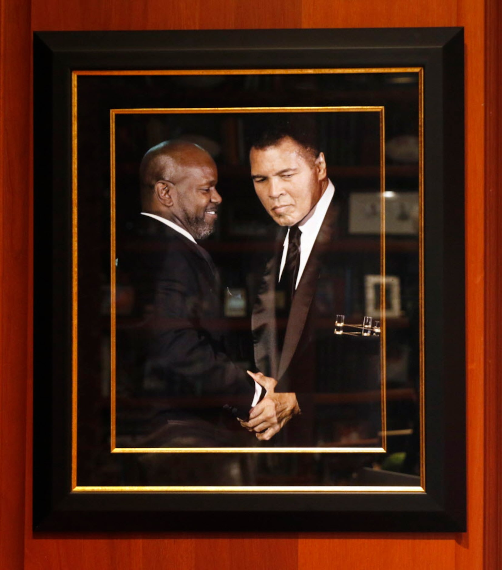 A photograph of former Dallas Cowboys running back Emmitt Smith with Muhammad Ali hangs in...