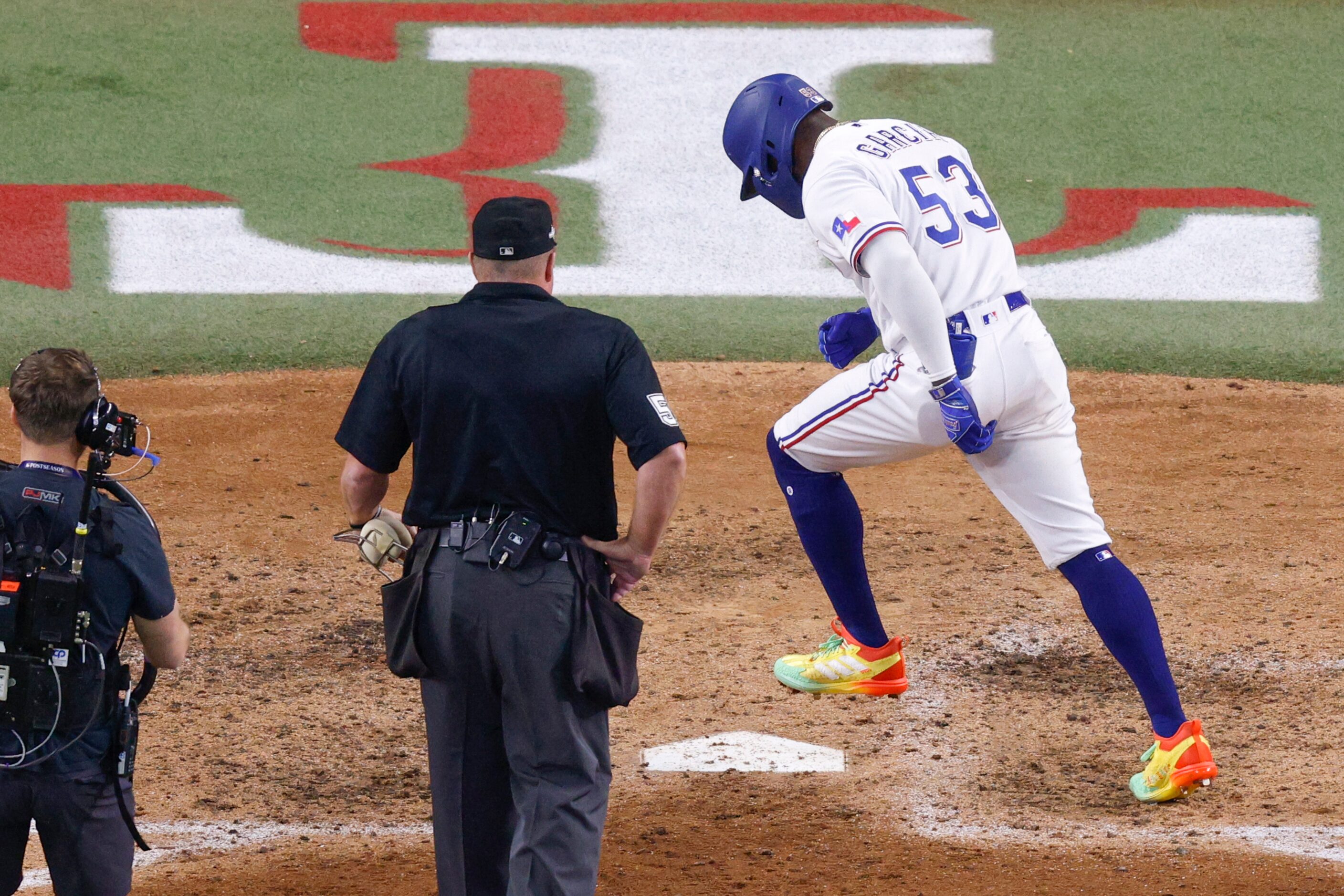 Texas Rangers right fielder Adolis Garcia (53) stomps on home plate after hitting a...