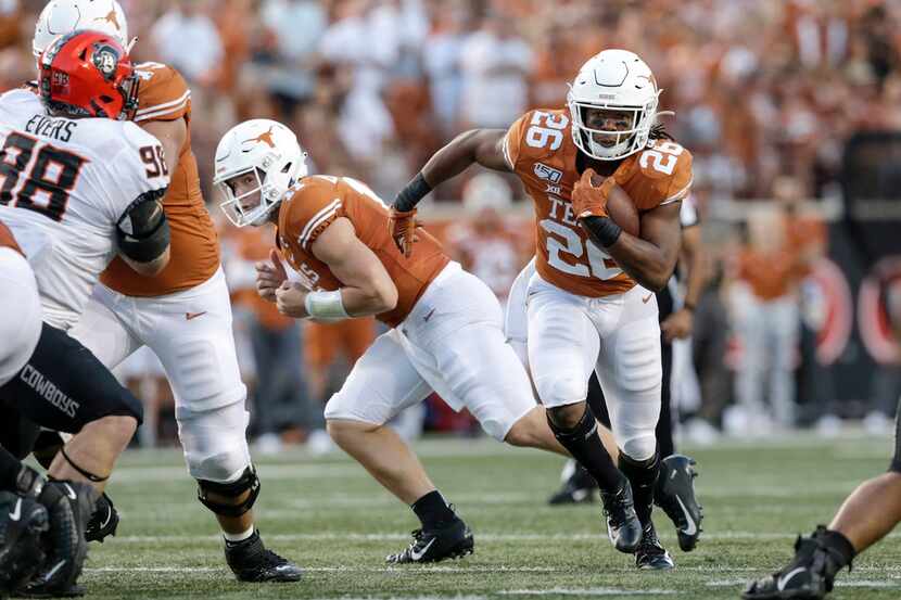 Texas running back Keaontay Ingram, No. 26, runs the ball during the first half of the...