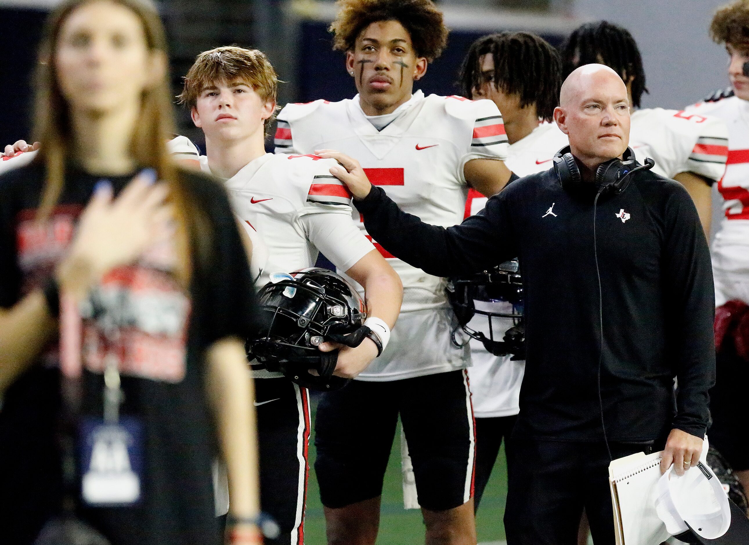 Lovejoy High School head coach Chris Ross has a hand on the shoulder of Lovejoy High School...