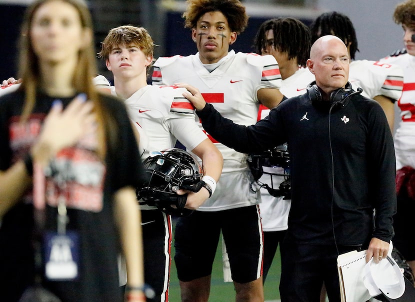 Lovejoy High School head coach Chris Ross has a hand on the shoulder of Lovejoy High School...