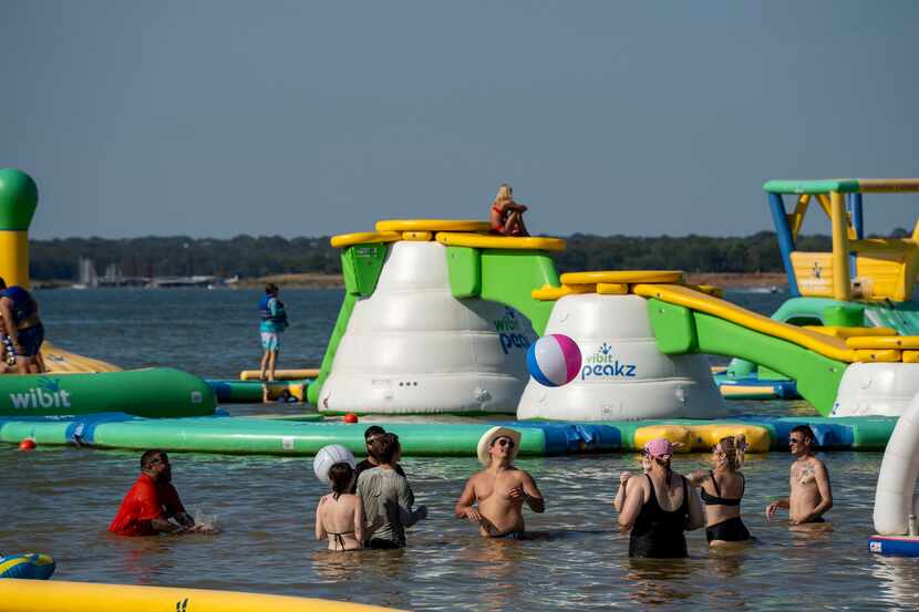 At Grapevine Lake, a floating playground features slides, trampolines and inflatable...