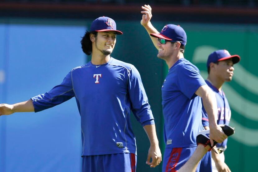 Texas Rangers pitchers Cole Hamels, right, and Yu Darvish of Japan, share a laugh during a...