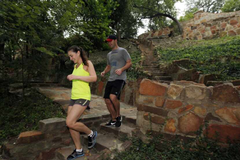 Ashley Agan and her husband, Chris Marr, exercise on hillside stairs that were part of a...