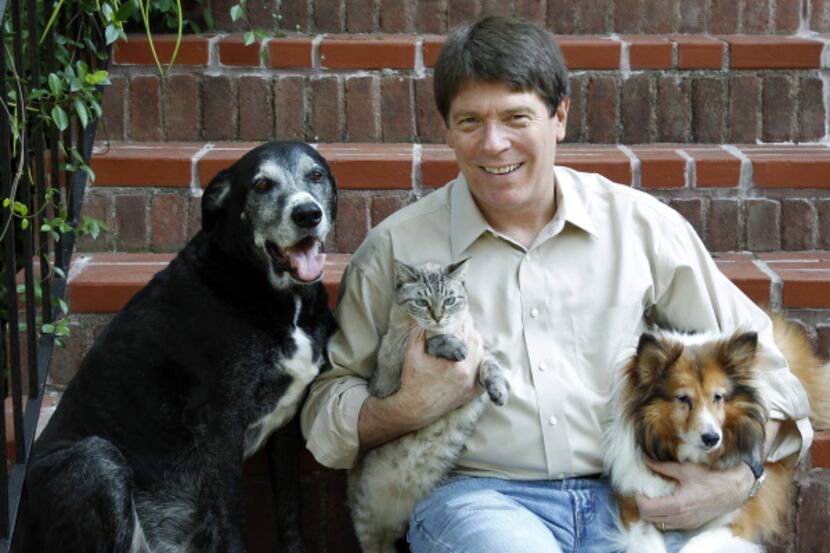 Animal law specialist Randy Turner sits with his two dogs, Barney and Lady Bird, and one of...