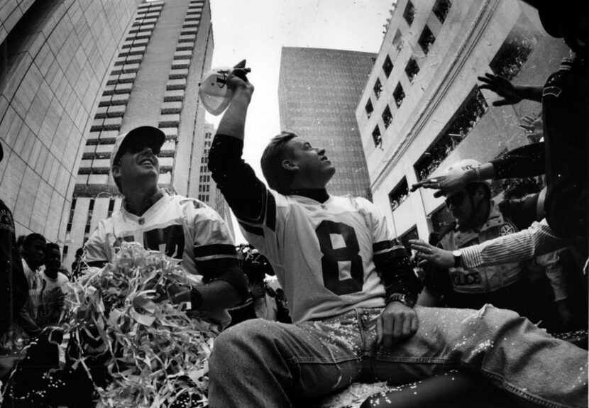 Jason Garrett (left) and Troy Aikman take in the adoration from Cowboys fans during the...