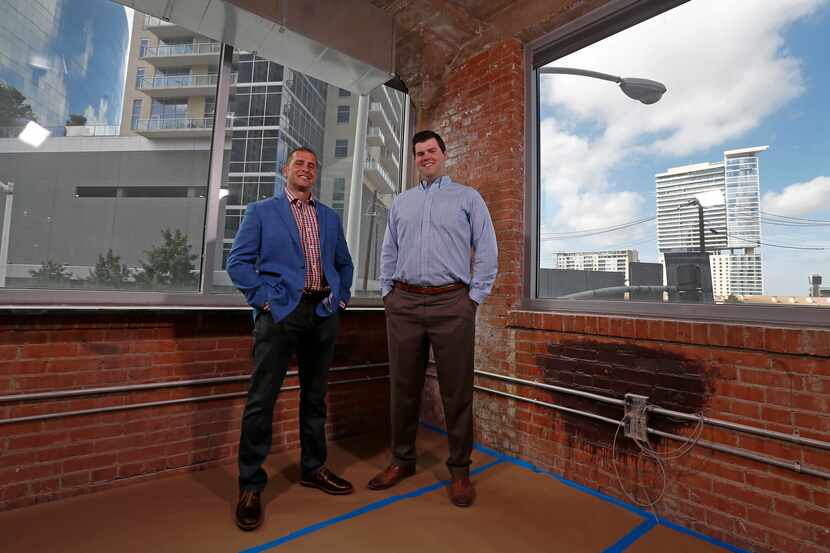 Josh McLeod (left), vice president of Regus, and Brian Bigham, area manager of Regus, pose...