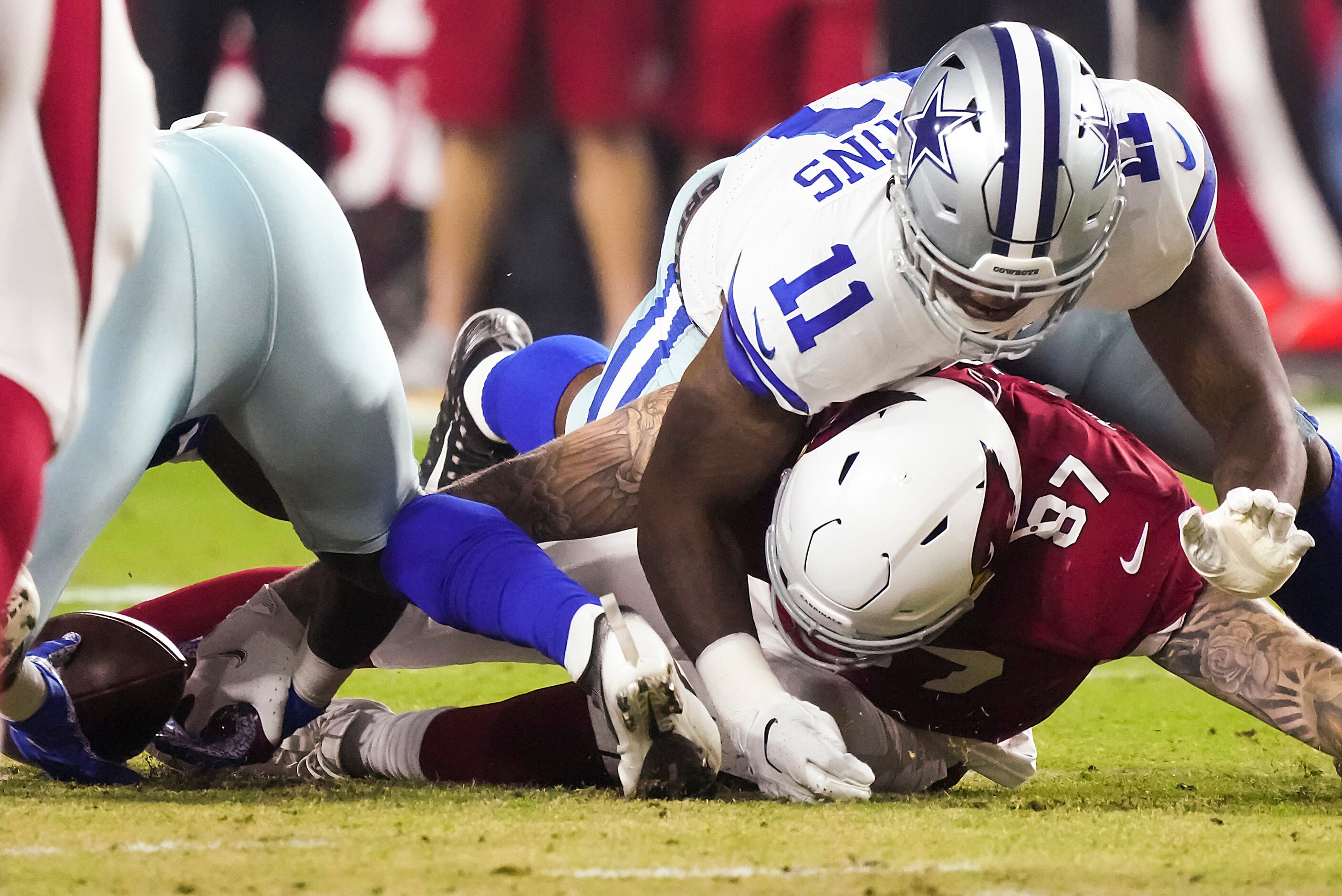 Dallas Cowboys linebacker Micah Parsons (11) comes down on Arizona Cardinals tight end Maxx...