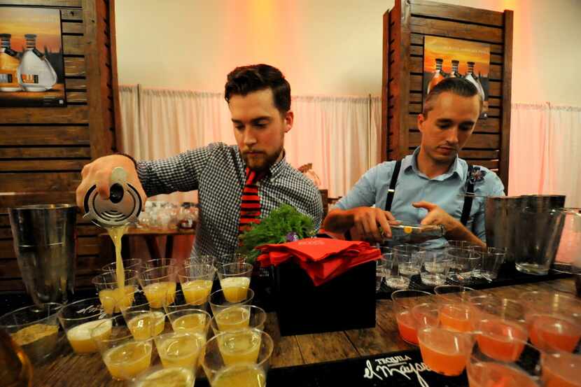 Matt Orth and Kyle Hilla prepare cocktails for guests at the DFW Restaurant Week kick-off...