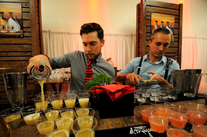Matt Orth and Kyle Hilla prepare cocktails for guests at the DFW Restaurant Week kick-off...