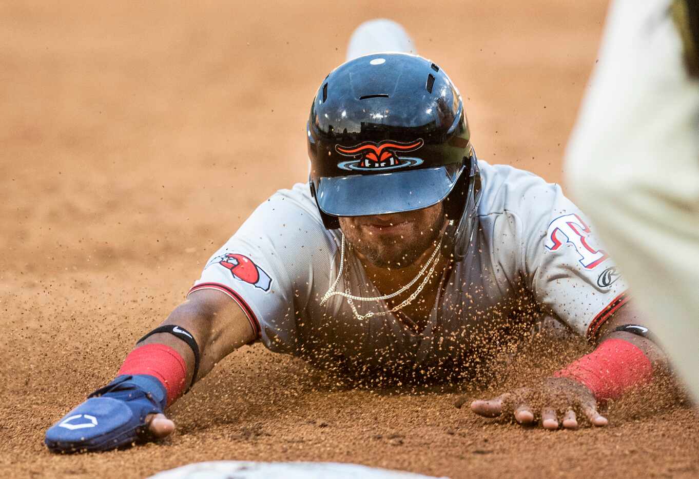 Hickory Crawdad's Ezequiel Duran (17) slides into third base on a hit and run during the...