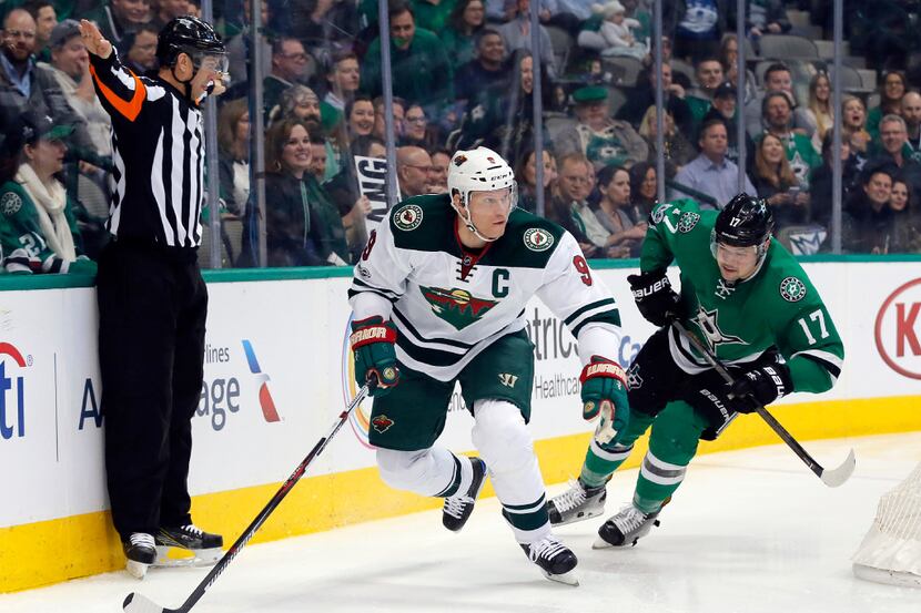 Minnesota Wild's Mikko Koivu (9) of Finland moves the puck from behind the net as Dallas...