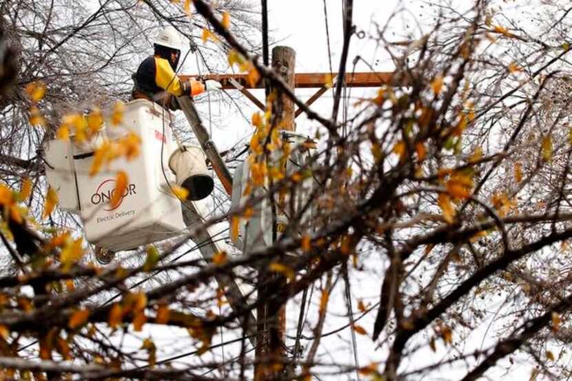 Oncor crews, including lineman Flavio Arellano, worked to restore power in North Texas after...