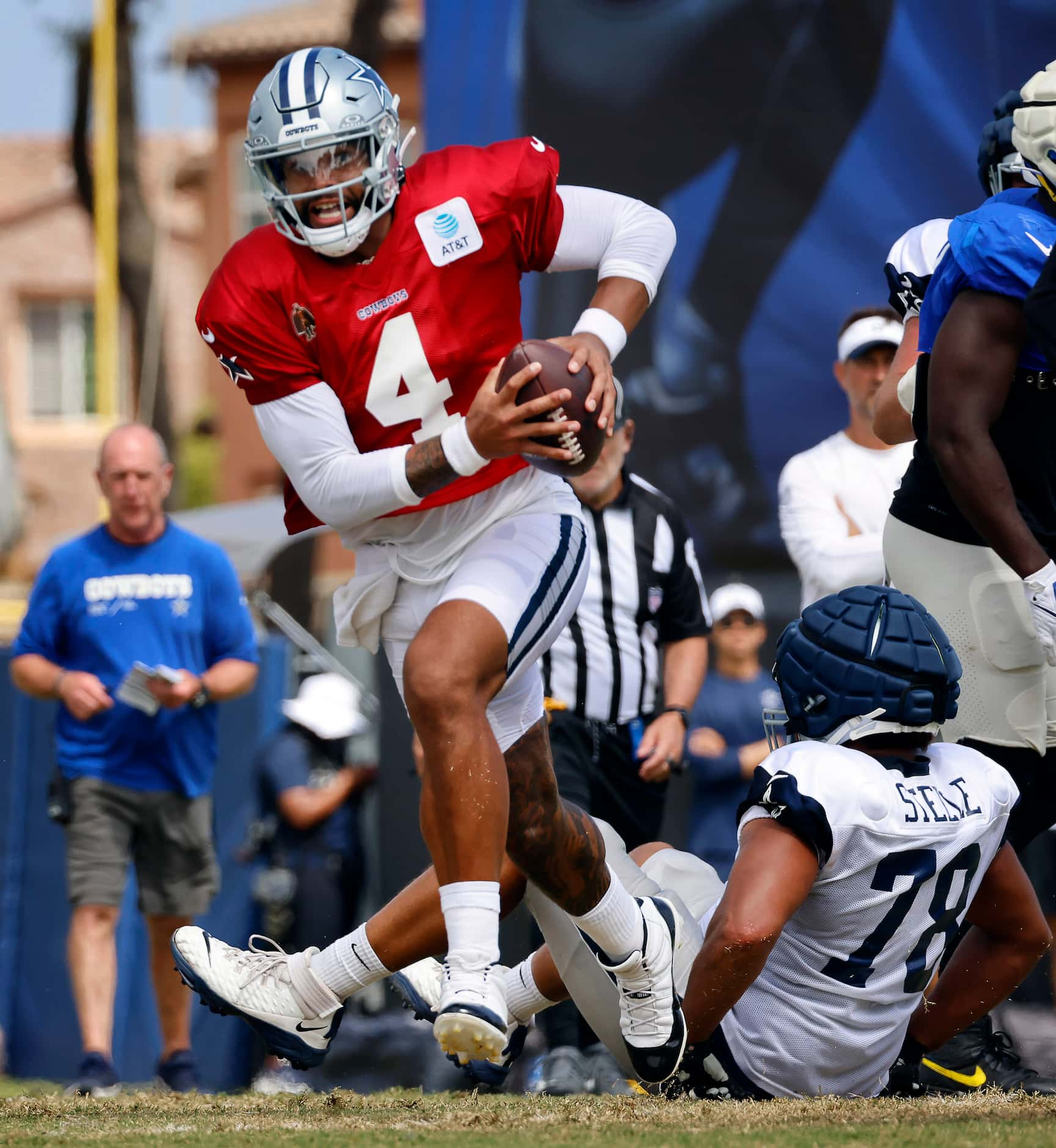 Dallas Cowboys quarterback Dak Prescott (4) escapes the pocket and rolls out looking for a...