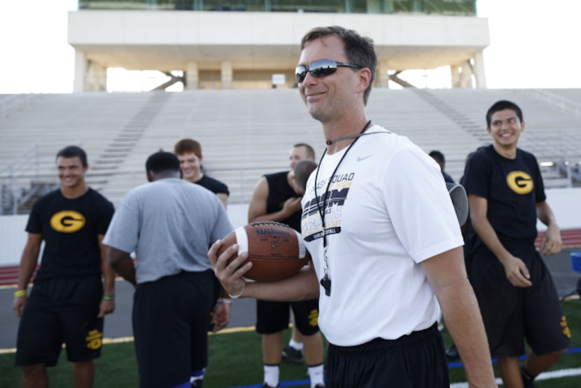 Jeff Jordan, head football coach at Garland High School, runs a football practice at...