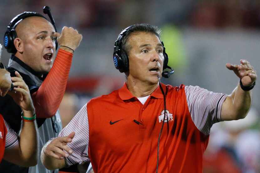 FILE - In this Sept. 17, 2016, file photo, Ohio State head coach Urban Meyer, right, and...