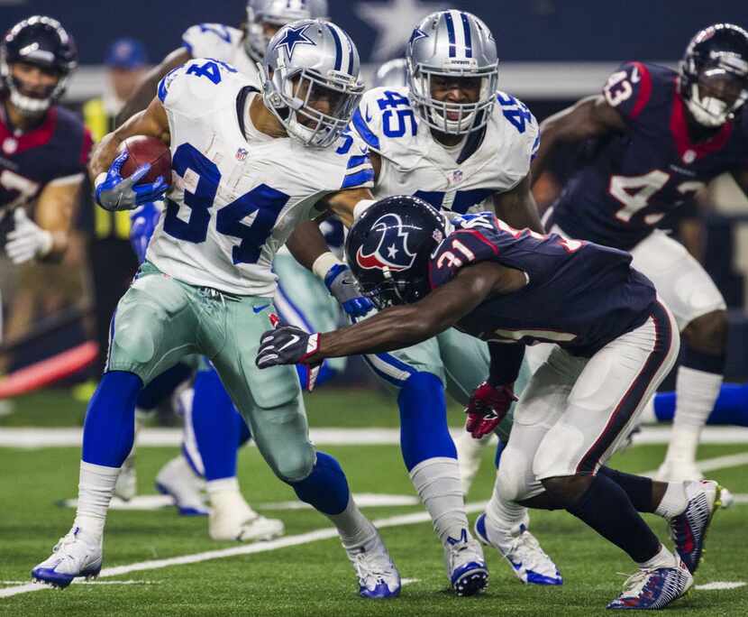 Dallas Cowboys running back Darius Jackson (34) is tackled by Houston Texans defensive back...