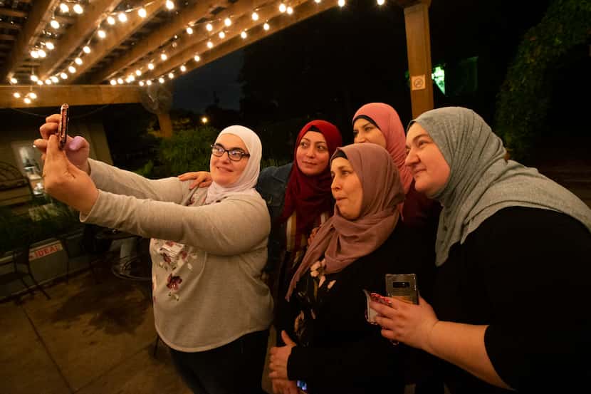 The community cooks from Syria, Chechnya and Turkey take a selfie following the Break Bread...