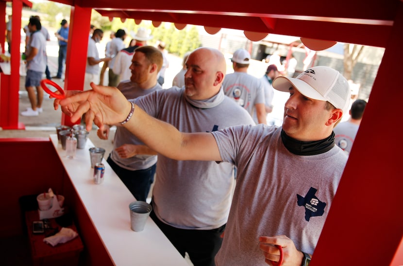 Scott + Reid General Contractors project manager Matt Matherne (right) tossed rings on...