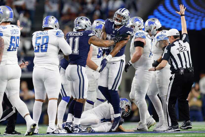 Dallas Cowboys defensive end Dorance Armstrong (92) celebrates with linebacker Micah Parsons...