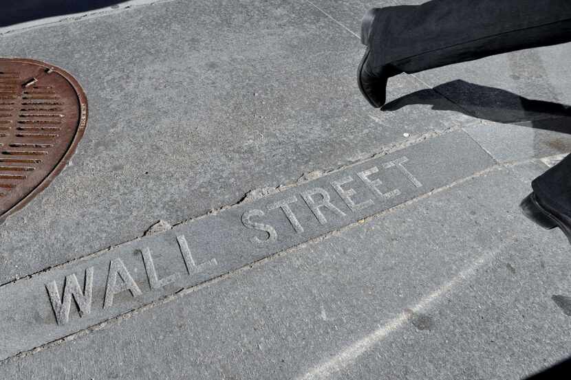 (FILES) This file photo taken on February 28, 2012 shows a Wall Street sign in a sidewalk...