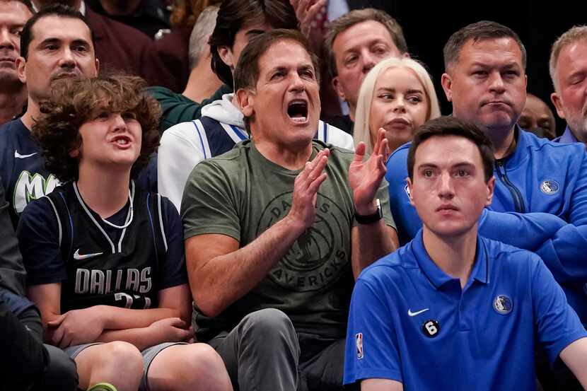 Dallas Mavericks owner Mark Cuban cheers during the first half of the tema's NBA basketball...