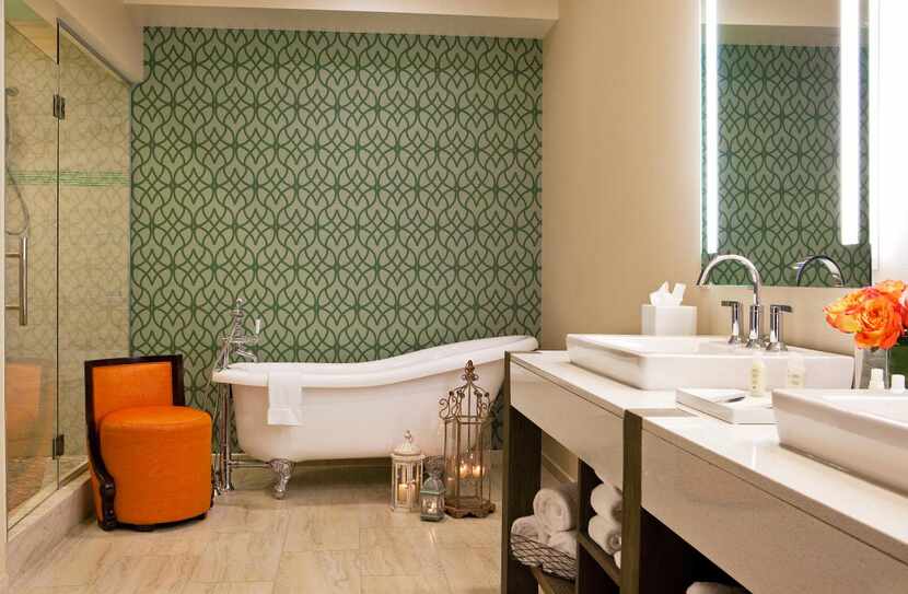 A pristine sink pairs with an old-fashioned claw foot tub to achieve the old-new mix Dallas...