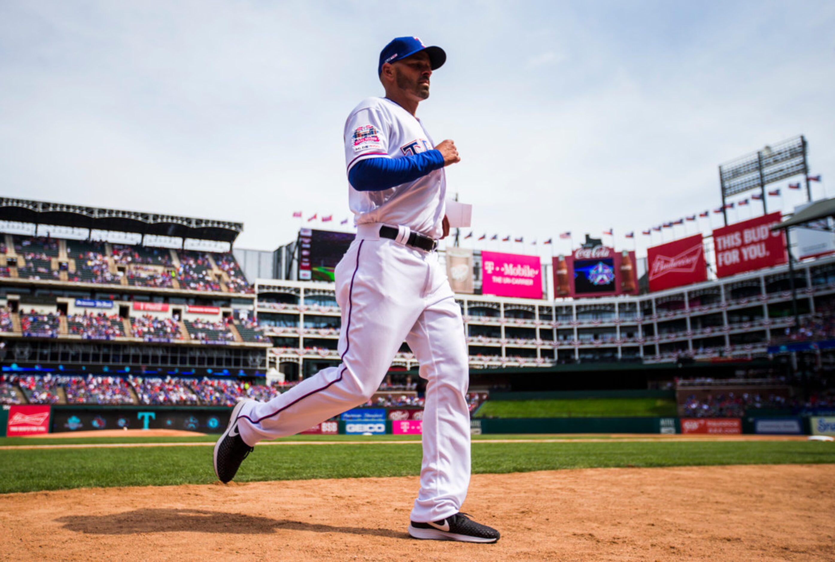 Texas Rangers manager Chris Woodward (8) runs to the dugout before an opening day MLB game...