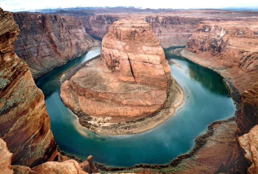 The Colorado River makes a scenic loop at Horseshoe Bend, one of the most photographed spots...