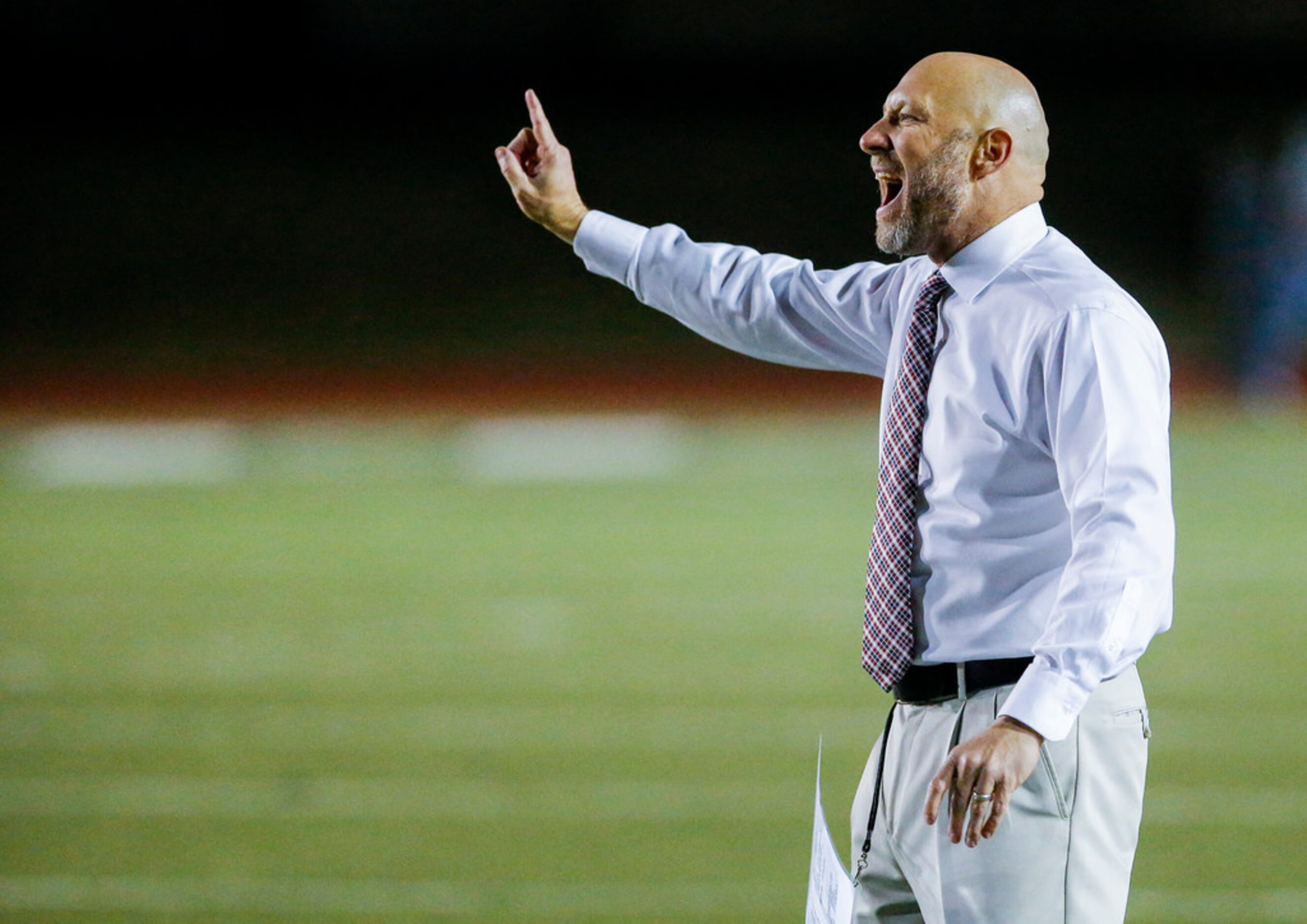 TXHSFB Grapevine Faith head coach Kris Hogan shouts instructions to his team during the...