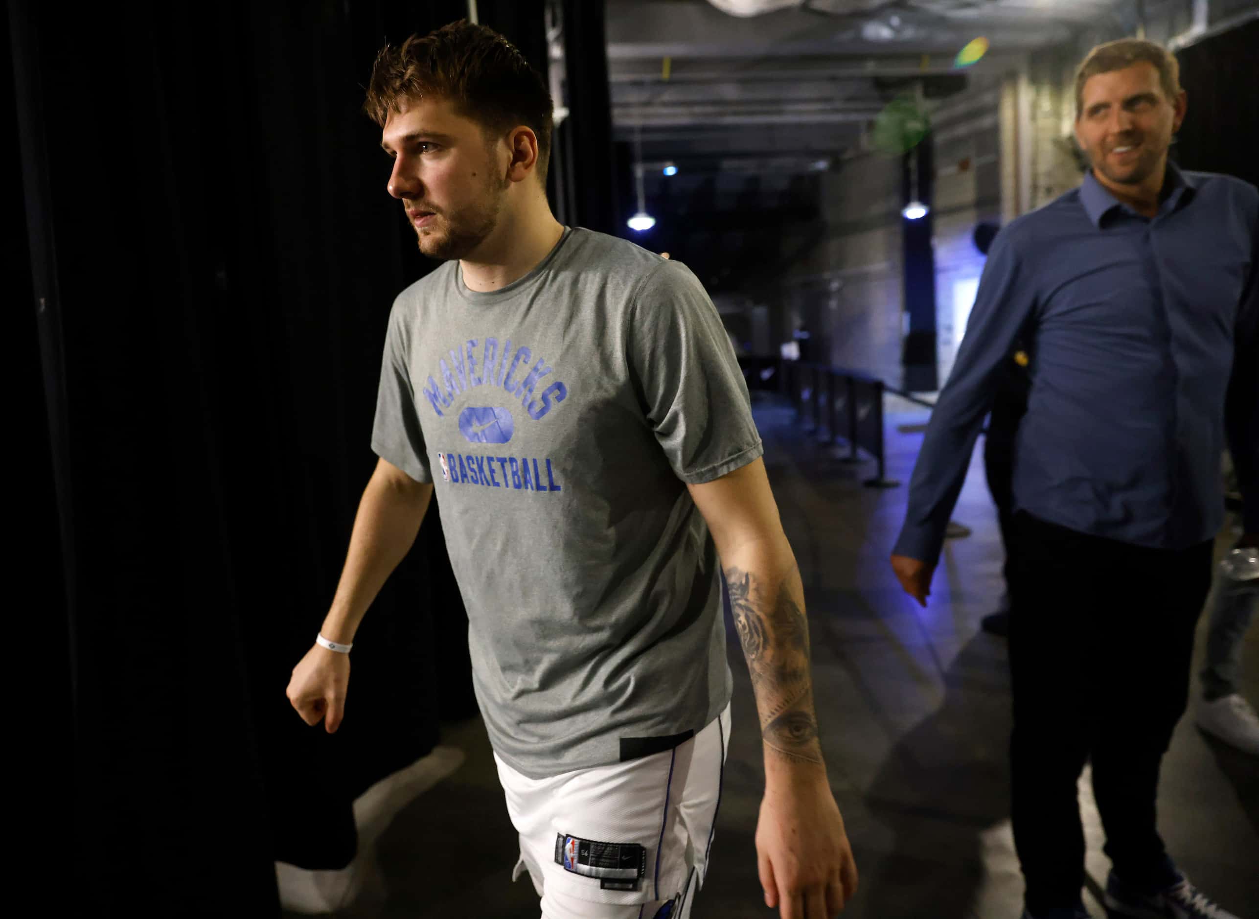 Luka Doncic walks to the locker room after visiting with former Dallas Mavericks forward...