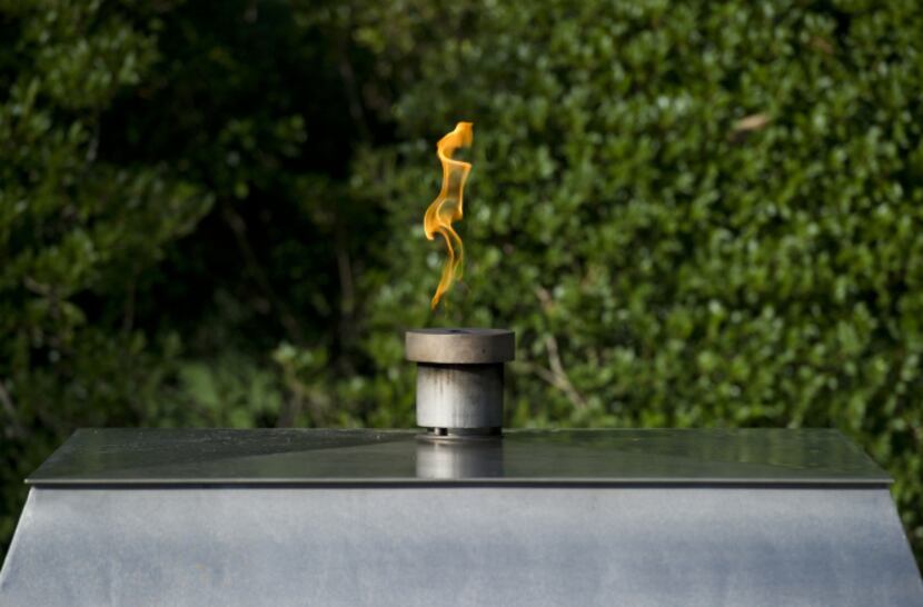 An eternal flame is lit at the gravesite memorial of former US President John F. Kennedy and...