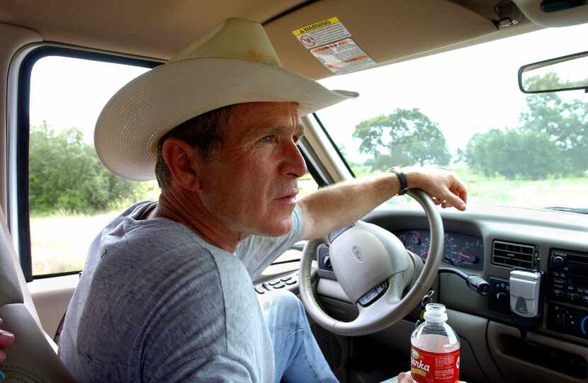 President George W. Bush drove his pickup at his 1,600-acre ranch in sun-baked Crawford,...