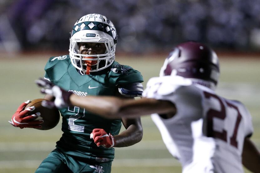 Waxahachie receiver Kenedy Snell (2) attempts to make a run past Ennis corner back Marqus...