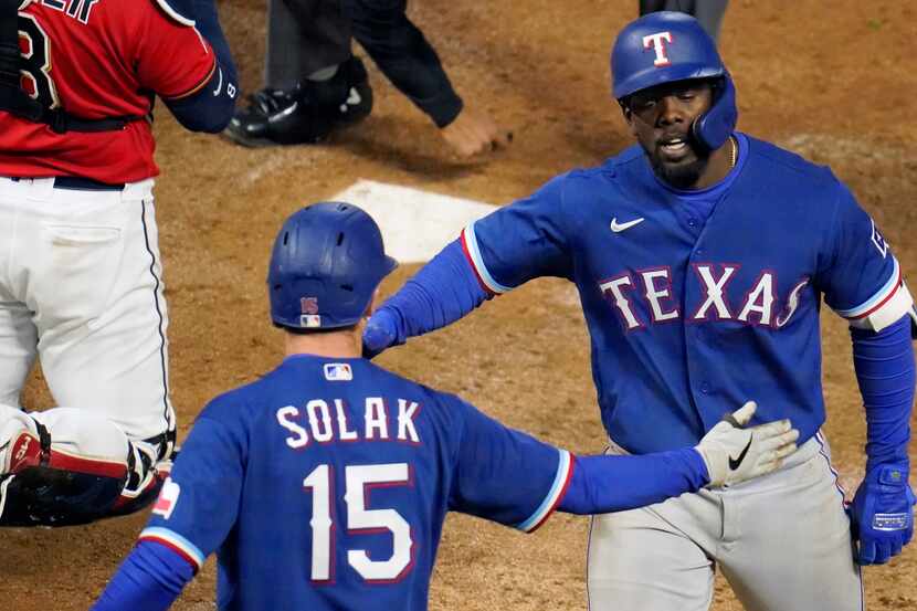 Texas Rangers' Adolis Garcia, right, is congratulated by Nick Solak after Garcia's two-run...