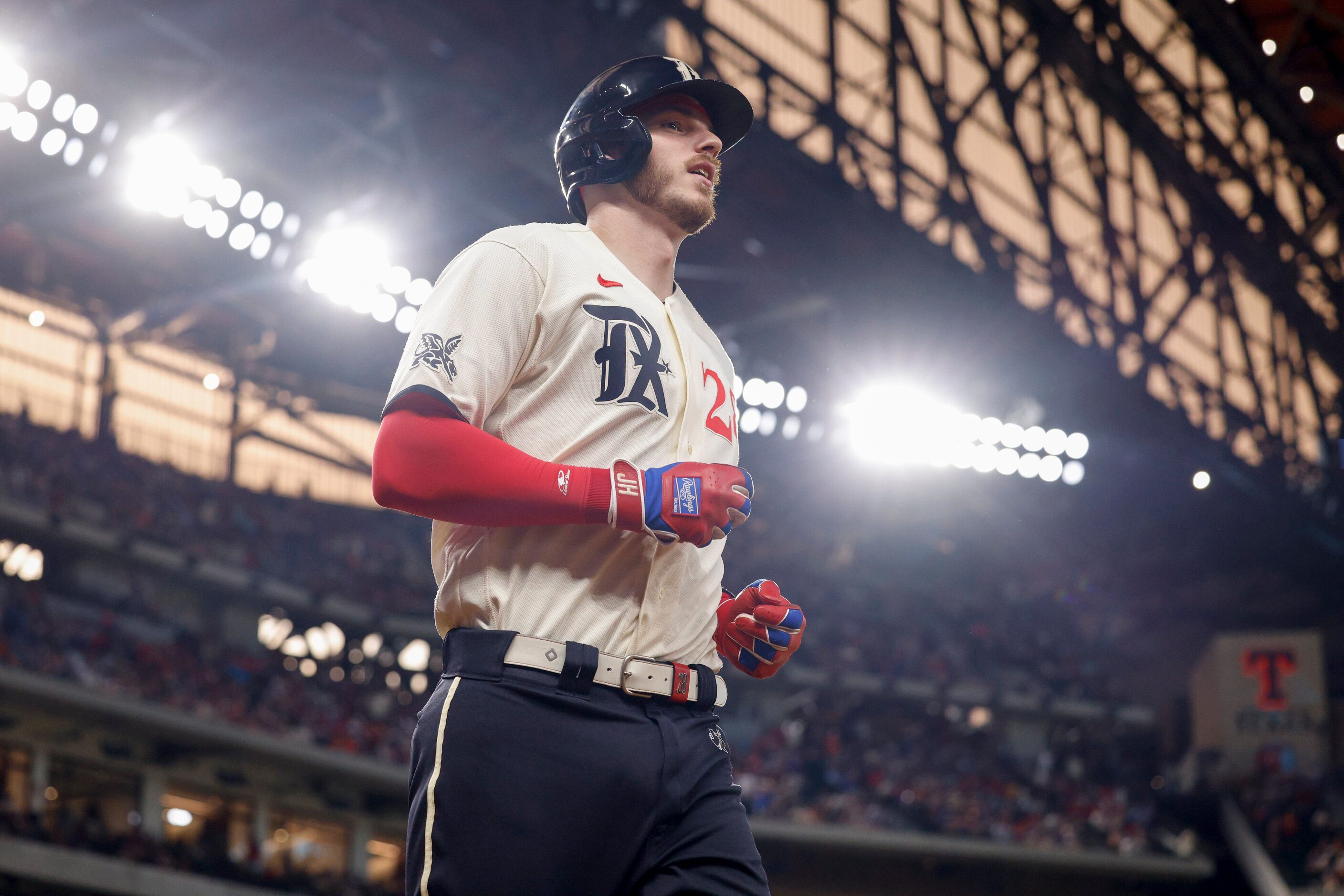 Texas Rangers catcher Jonah Heim (28) jogs back to the dugout after hitting a home run...