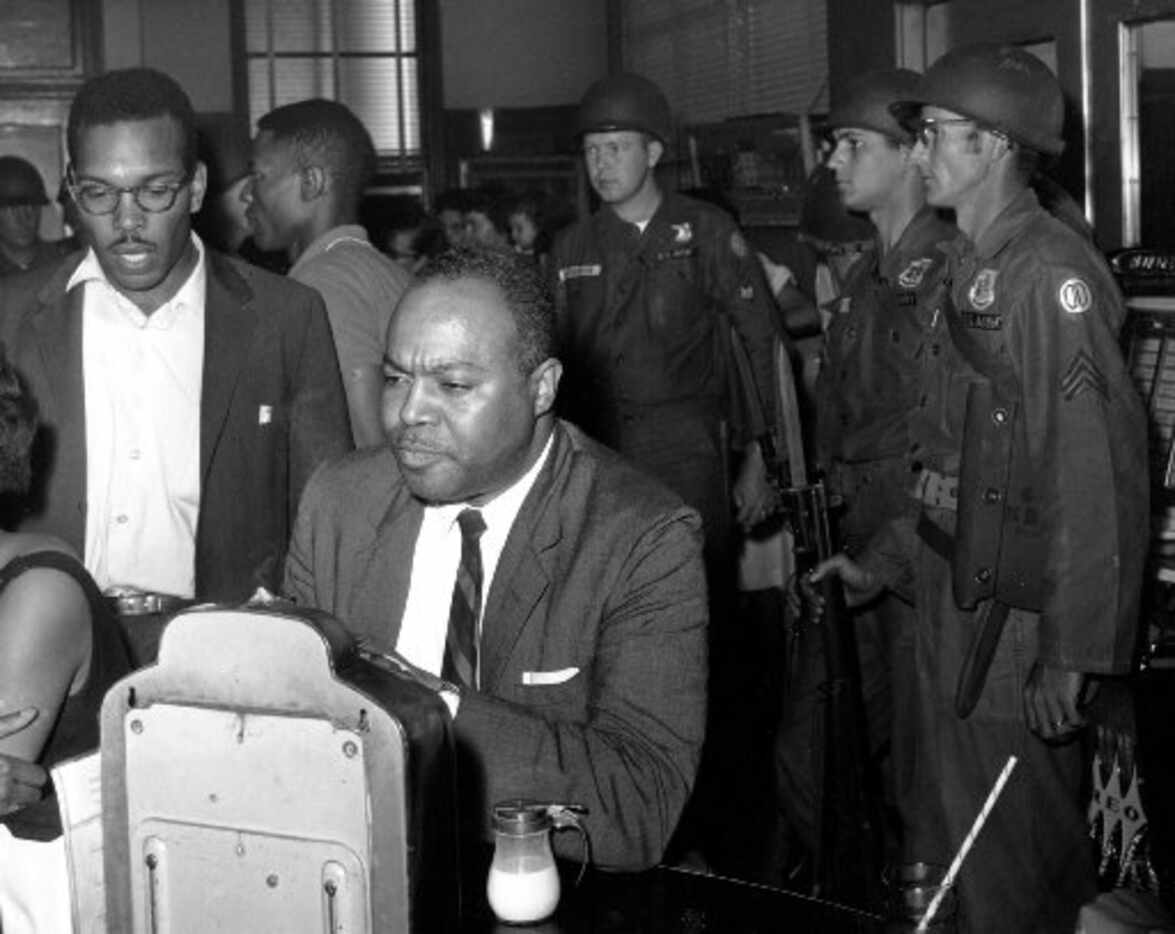 James Farmer, director of the Congress of Racial Equality, sits at a previously white lunch...