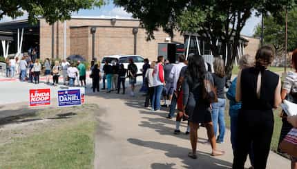 Long lines had early voters biding their time at Fretz Park Dallas Public Library on Monday.