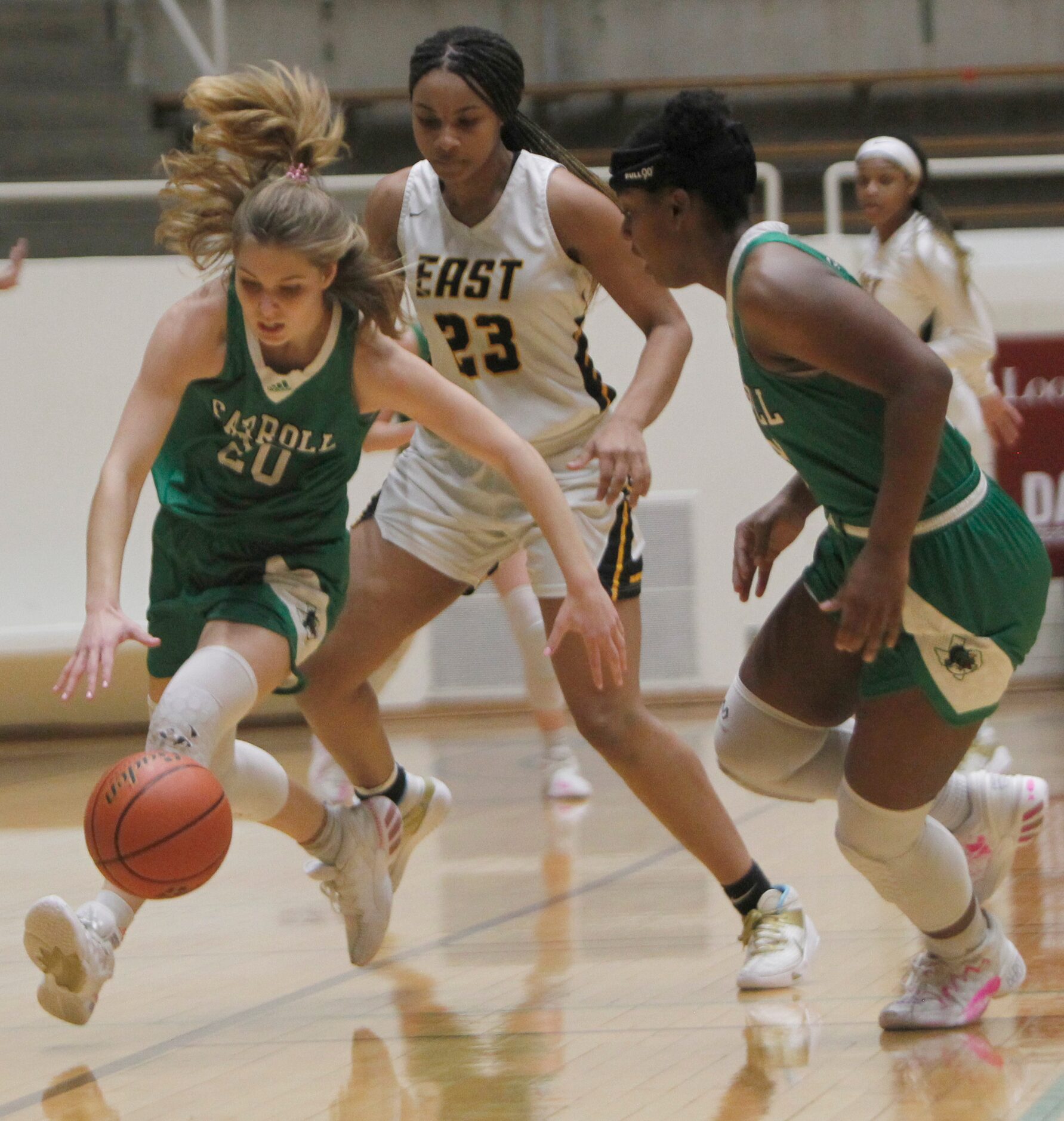 Southlake Carroll guard Camryn Tade (20) cases a loose ball as teammate Jordyn Sowell (33),...