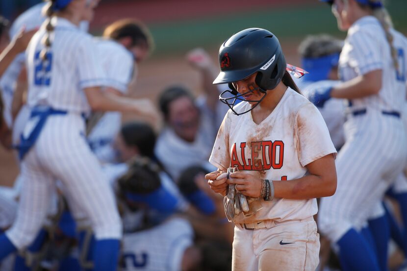 Aledo shortstop Macy Graf (1), a stranded baserunner in the bottom of the 7th inning, slowly...