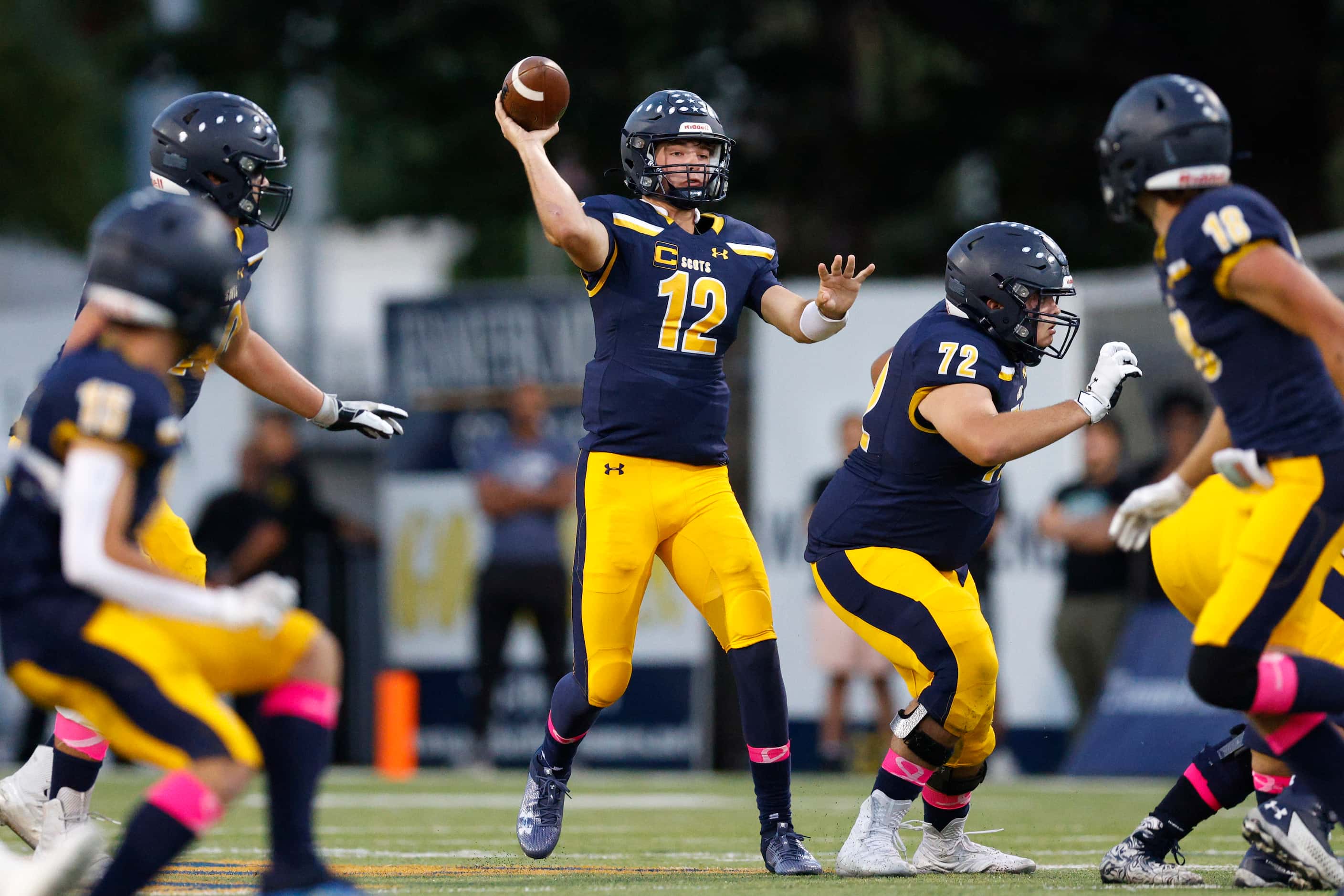 Highland Park quarterback Warren Peck (12) throws a pass during the first half of a District...
