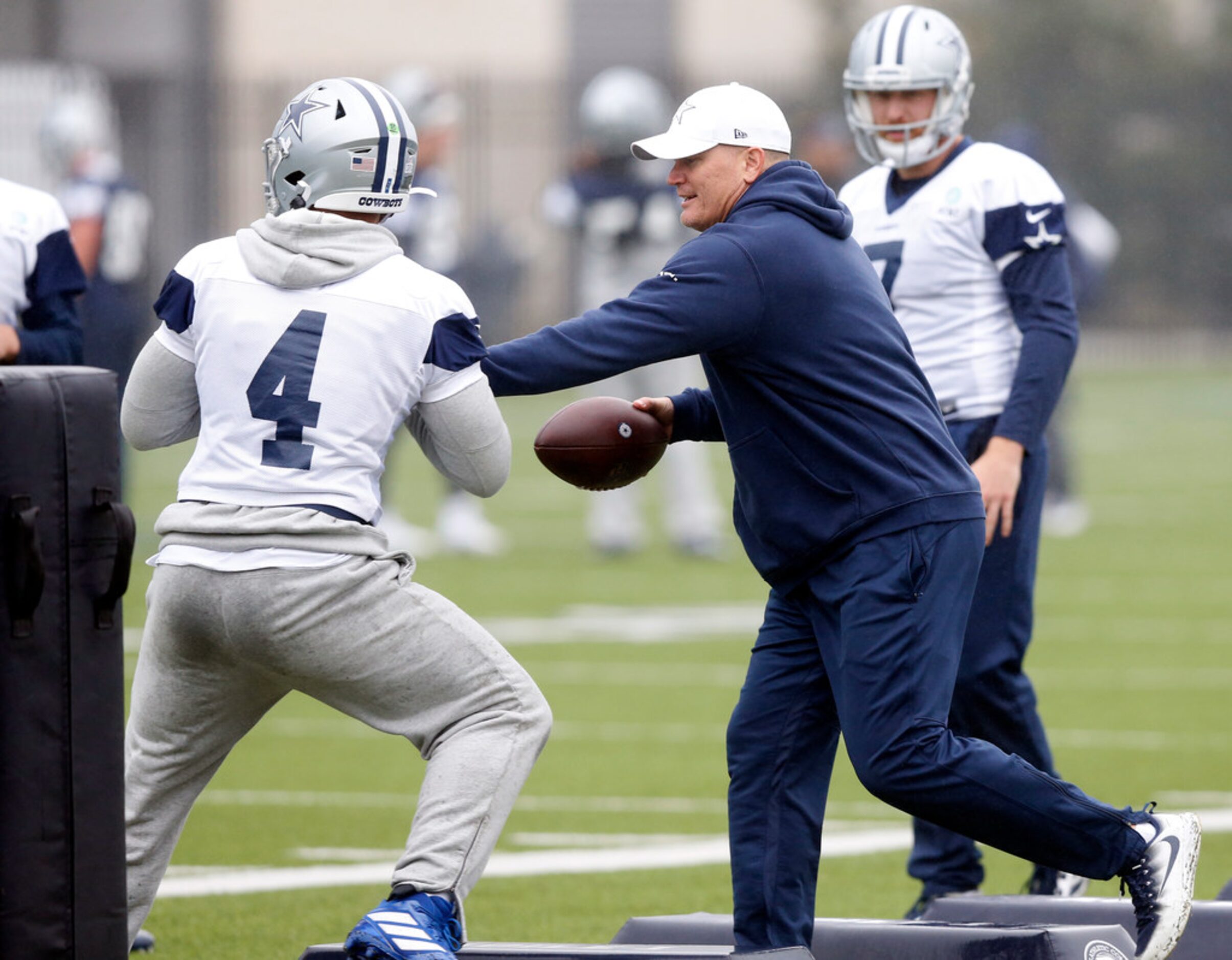 Dallas Cowboys quarterbacks coach Jon Kitna (right) pass rushes quarterback Dak Prescott...