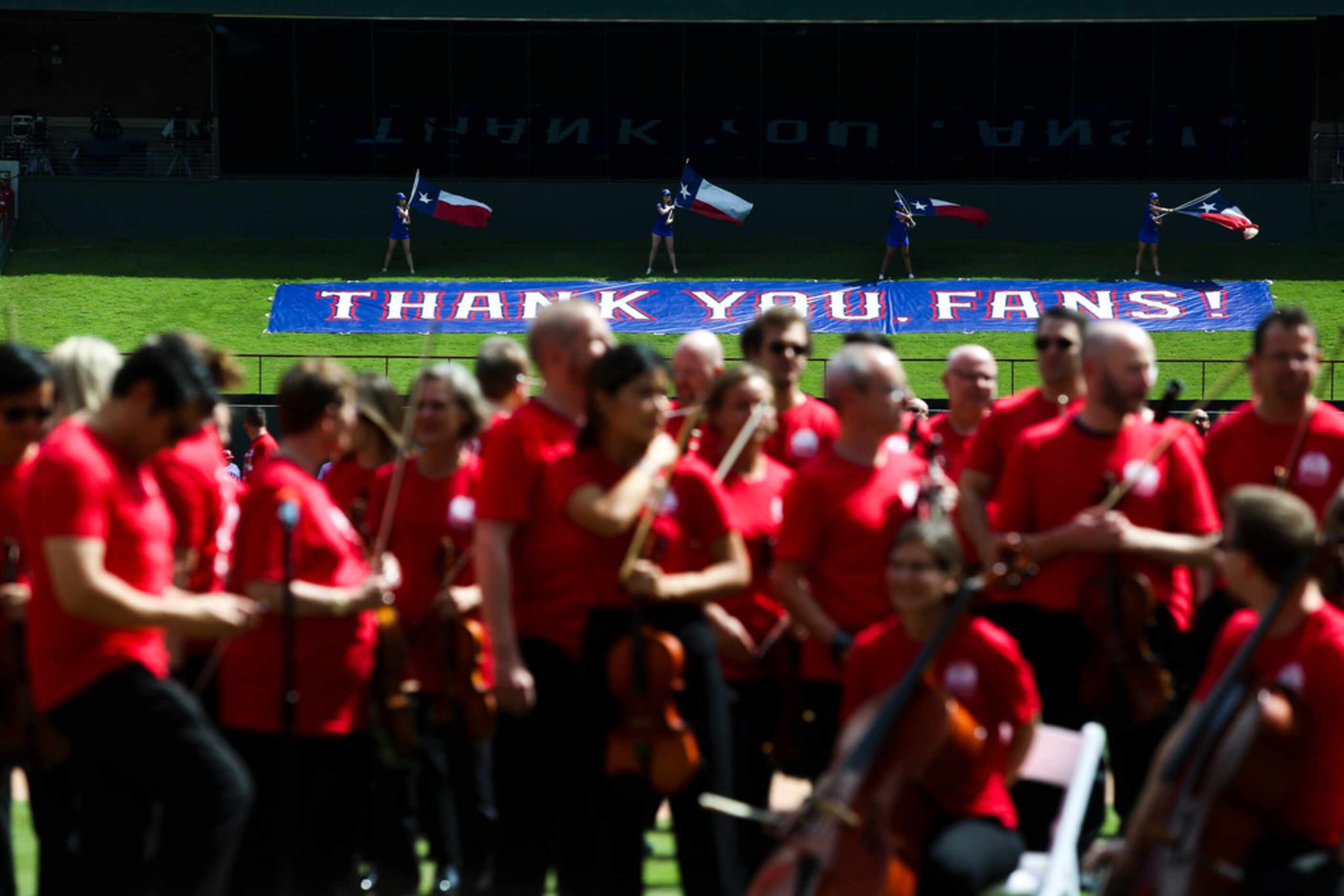 The Forth Worth Symphony Orchestra prepare to perform the National Anthem before a the...