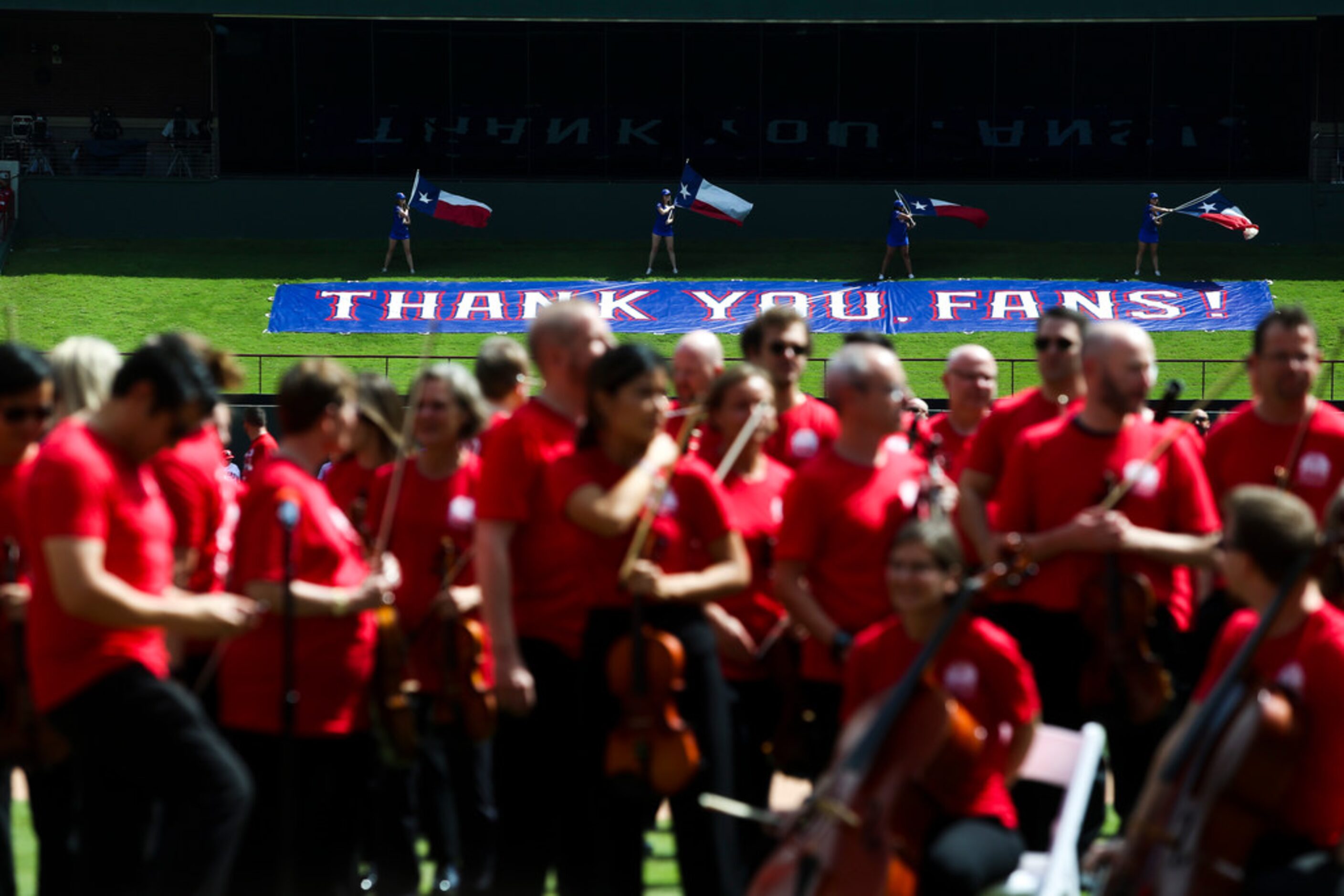 The Forth Worth Symphony Orchestra prepare to perform the National Anthem before a the...